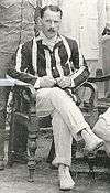 picture of Charles Lyon seated wearing cricket flannels and a blazer. Picture taken in India in 1908.
