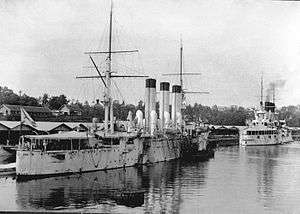Two warships tied up at a wharf