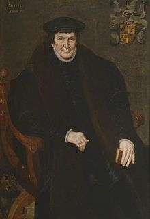 Portrait of a large man, seated, holding a book