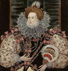 A three-quarter portrait of a middle-aged woman wearing a tiara, bodice, puffed-out sleeves, and a lace ruff. The outfit is heavily decorated with patterns and jewels. Her face is pale, her hair light brown. The backdrop is mostly black.