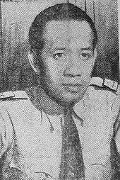 A man wearing a tie, looking forward