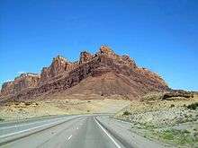 A mountain made from two layers of sandstone, the lower layer is a light color, while the upper layer is dark red.