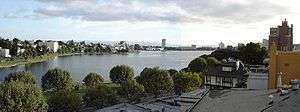 Panoramic photograph of the Lake Merritt Wild Duck Refuge, surrounded by the buildings of Oakland.