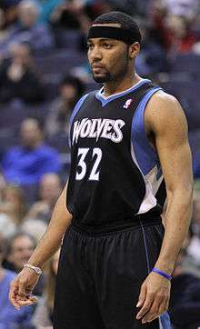 A full body shot of Lazar Hayward in a Timberwolves jersey, wearing a black headband