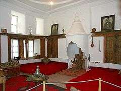 Two large beds near the floor, with a fireplace between them