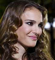 Natalie Portman looks to the camera's left, smiling