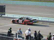 Black-and-red race car, with red Mobil Pegasus