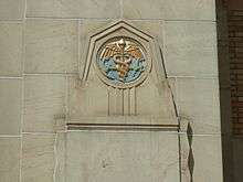 An anchor and caduceus  on the exterior of a building