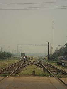 an X-shaped interception of railroads with a repair crew carrying out maintenance
