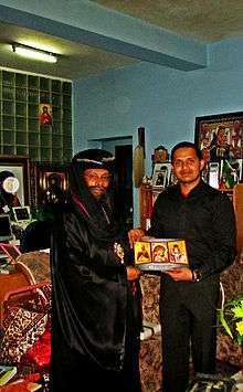 Two men holding an icon